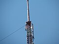 A detailed view of the guy wires and top part of the mast.