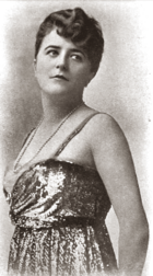 young white woman with shorter hair, standing, in evening gown, looking over her left shoulder