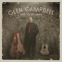 The album cover features Campbell wearing a long black coat standing with an open guitar case to his right and an acoustic guitar to his right. Above him are the words "GLEN CAMPBELL / GHOST ON THE CANVAS" written in white.