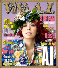The album cover is produced in the format of a magazine cover. A mid-shot of Ai is featured against a pale pink background in the centre. She has a floral headdress, red hair and blue contacts, and is wearing a blue denim jacket with many button badges. Behind and above her head reads ViVa A.I. in a bordered font identitcal to US magazine Rolling Stone's font. To the left and right of Ai are the titles of the songs in blue, yellow and pink.