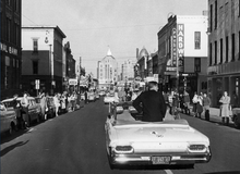 John F. Kennedy campaigning and driving through State Street in downtown Rockford, 1960 John F Kennedy campaigns in downtown Rockford circa October 1960.png