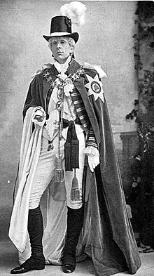 tall, clean-shaven white man in court dress and robes of the Order of St Patrick