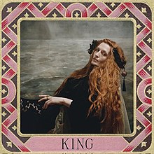 A picture of Florence Welch sitting sideways while gazing into the camera. The picture is surrounded by a medieval-styled border with the text "King" written below.