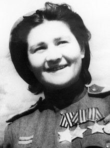 Photo of Stanelienė in uniform wearing all three Orders of Glory and other medals