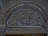 Carved stone tympanum showing Richard Arkwright apparently making calculations alongside experimental models of the water frame