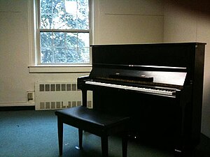 Practice room with upright piano.