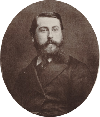 Middle aged white man with short, dark hair and a bushy beard