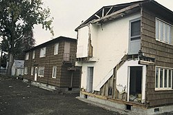 And image of the Amazon Family Housing Complex during its demolition in 1995. The buildings are dilapidated.