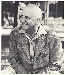 William M. "Skipper" Beals seated in front of the original Homestead Building on the campus of Leelanau for Boys in around 1940.