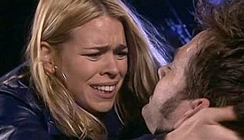 Rose Tyler (Billie Piper) cradles a dying Doctor (David Tennant) after he has been shot by a Dalek extermination ray.