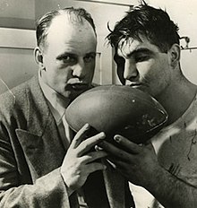 A picture of Bob Voigts and Alex Sarkisian kissing the game ball after the Rose Bowl in 1949