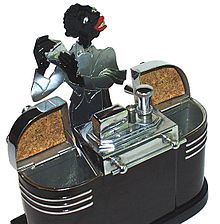 This elaborate Art Deco Ronson tabletop cigarette lighter, made in 1936, is an example of an everyday consumer item rendered in classic darky iconographical style. Ronson figural lighter.jpg