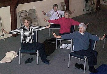 Seniors practicing chair yoga