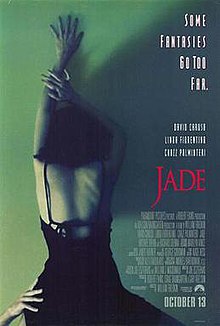 A woman in an open back black dress, arm outstretched above her head, is leaning against a green wall. From below, another hand holds her at the waist. The top right of the poster features the tagline "Some fantasies go too far."