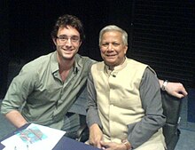 Yunus (right) at a book signing at the London School of Economics Yunus at LSE.jpg