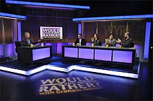 Graham Norton and four panelists playing "Would You Rather...?" on set