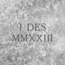 The words "I Des" carved in stone, with "MMXXIII" (2023) carved below it
