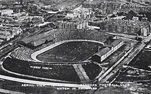 Ibrox Park in 1910, with the Copland Road exit at the far corner of the stadium. An equivalent staircase can be seen descending the nearest corner. Second Ibrox Park 1910.jpg