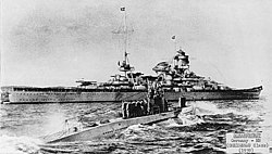 U-47 returns to port after sinking HMS Royal Oak in October 1939. The battlecruiser Scharnhorst is seen in the background.