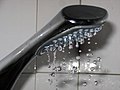 Water droplets forming out of a shower head.