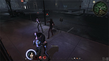 A screenshot of a city environment in a 3D game, showing four characters, one of which is a vampire, and three of which are humans. The player-controlled vampire is shown sucking blood from a human character's neck.