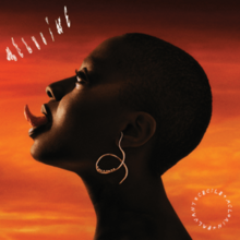 A profile shot of Salvant with her tongue sticking out in front of a brown and orange backdrop.