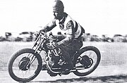 Col Stewart races his speedway motorcycle wearing a wooden helmet. Photo taken around 1930.