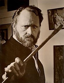 Irv Docktor in his studio in the 1960s, brandishing a paintbrush.