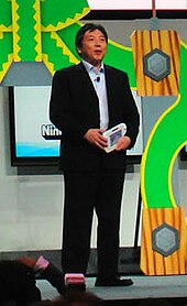 Director Katsuya Eguchi Katsuya Eguchi at E3 2012 Nintendo Conference (edited).jpg