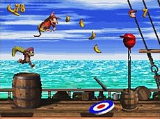 At the end of each level, the player must jump on a target pad for a chance to earn one of a series of quickly changing rewards, such as an extra life balloon. Diddy Kong's Quest gameplay.jpg