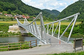 Pedestrian and cyclist bridge, with village Tremerje in the back