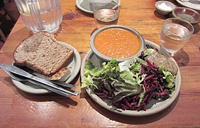 A lunch dish of soup, salad and bread served on stoneware at Food for Thought