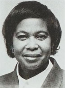A short-haired black woman in a business suit