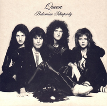 The four members of the band sit together in front of a sandy-coloured background wearing predominantly black clothing. Freddie Mercury appears to be the dominant figure, sat in front of the other three members. From left to right, John Deacon, Mercury, Brian May, Roger Taylor. All four individuals are looking directly at the camera with a neutral expression on their face. Above the band is some black text, printed in an elegant, italic font face. The word "Queen" followed by "Bohemian Rhapsody", the latter of which is positioned under the band name in the same format yet smaller font.