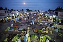 A farmers' market at twilight in Layyah, Pakistan Layyah fruit vegetable market.jpg