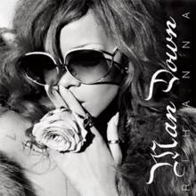 A black and white image of Rihanna wearing oversized sunglasses with "Man Down" written vertically on the right hand side