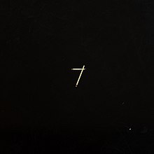 A black cover with two matchsticks making a "7" on it