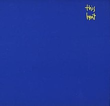A blue background with the words "This Heat" written in small, yellow handwritten font in the top-right quarter of the image.