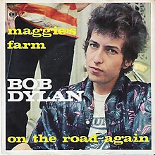 Single sleeve of Dylan in a blue jacket staring at the camera with a person standing behind him, his name, and large song titles.