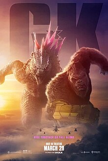 A giant lizard with pink spikes standing shoulder-to-shoulder with a giant ape. In the clouds below are several attack helicopters.