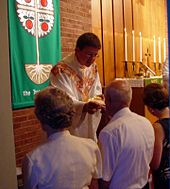 A Lutheran pastor administers the Eucharist during the Divine Service at the chancel rails. Communion3.jpg
