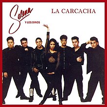 Album cover for Selena's single "La Carcacha" featuring a posing Selena with long wavy hair and hoop earrings, against a white background, surrounded by her band Los Dinos.