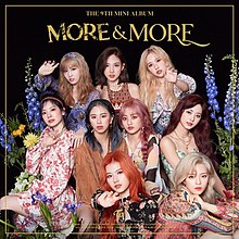 Black background with the words "The 9th Mini Album More & More" featuring the nine members of twice in floral dresses with some reaching forward toward the camera.