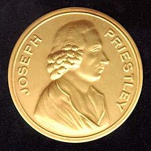 Photograph of a gold medal, which says "Joseph Priestley" around the edge and has a profile of a man stamped in the center
