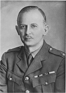 A middle-aged man in military uniform, wearing three medals and a major's rank. One is overlaid with the oak leaf denoting a mention in despatches.