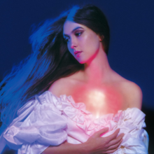 A picture of Weyes Blood in a white dress looking sideways against a dark blue background. A red light shines on the singer's chest, while blue lighting is shining against her hair.