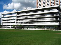 Velasco Hall, a white building with long rows of windows