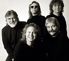 A black-and-white image showing all five members of country rock band The Tractors
