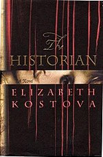 Dark brown book cover saying "The HISTORIAN"; then "A Novel" in a shiny gold stripe, then "ELIZABETH KOSTOVA". A few thin reddish streaks stretch from the top almost to the bottom.
