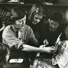 Fitzgerald shows her children paper dolls that her mother, Zelda, made for her.  From the February 1959 Life Magazine issue by Robert Phillips.